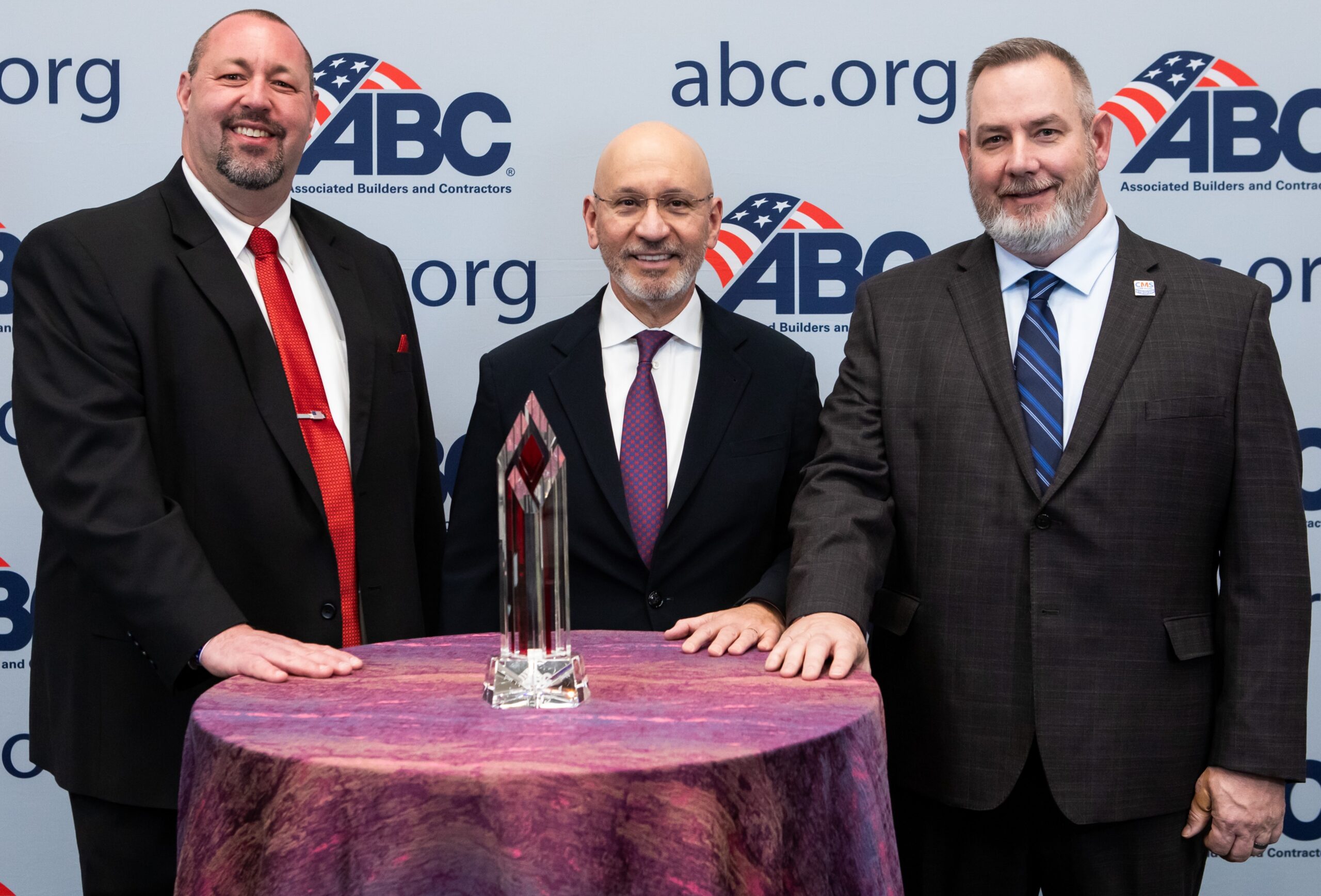two men holding safety awards